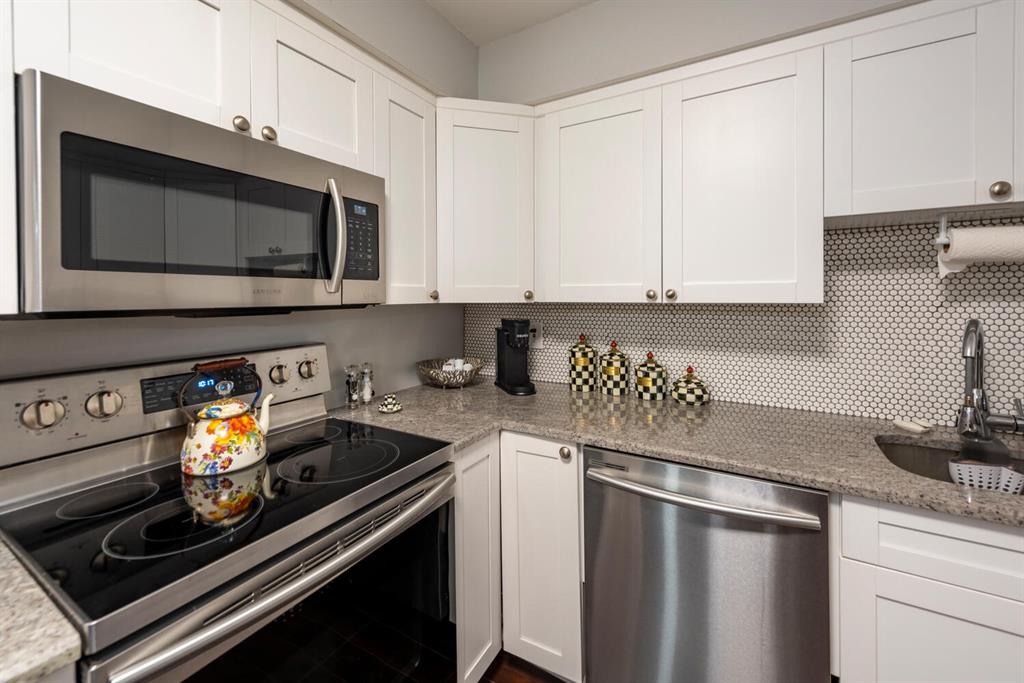 16251 Golf Club Road, Unit 305 Weston, FL 33326 - Photo 20 of 43 a kitchen with stainless steel appliances granite countertop a stove and a microwave