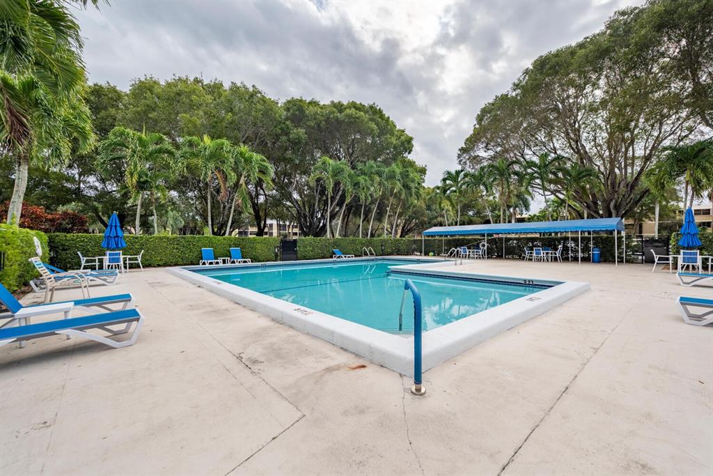 16251 Golf Club Road, Unit 305 Weston, FL 33326 - Photo 24 of 43 a view of outdoor space with swimming pool and trees