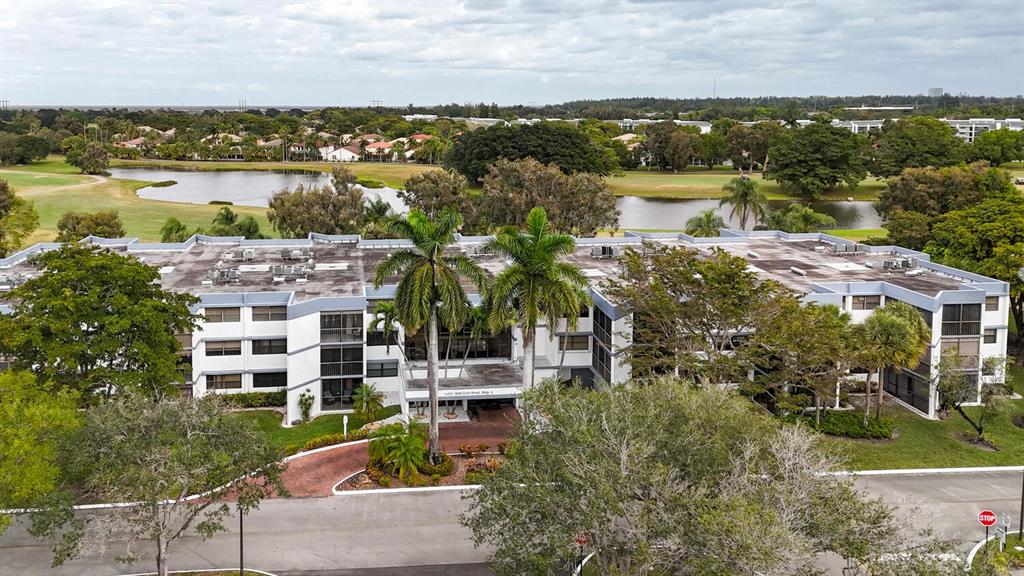 16251 Golf Club Road, Unit 305 Weston, FL 33326 - Photo 25 of 43 a view of a lake with a building in the background