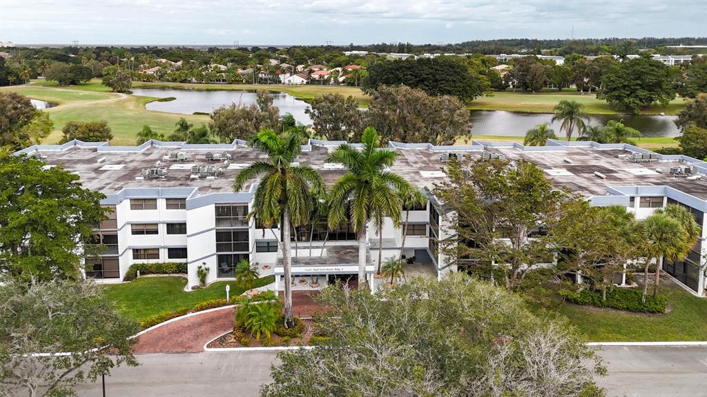 16251 Golf Club Road, Unit 305 Weston, FL 33326 - Photo 26 of 43 a view of a lake with building in front of it