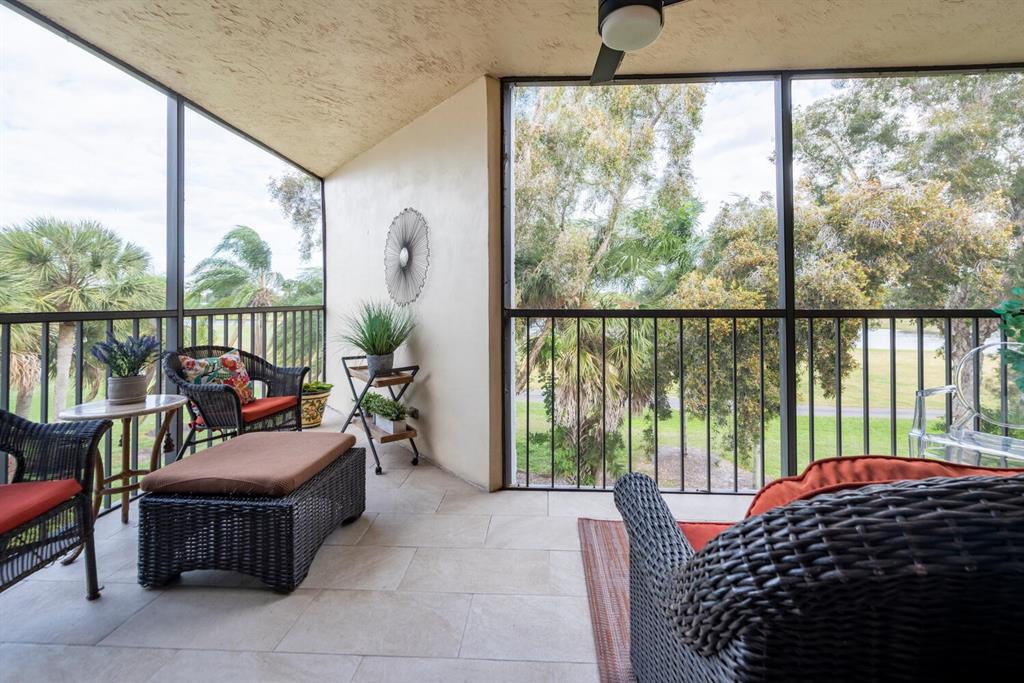 16251 Golf Club Road, Unit 305 Weston, FL 33326 - Photo 9 of 43 a bedroom with furniture and a large window