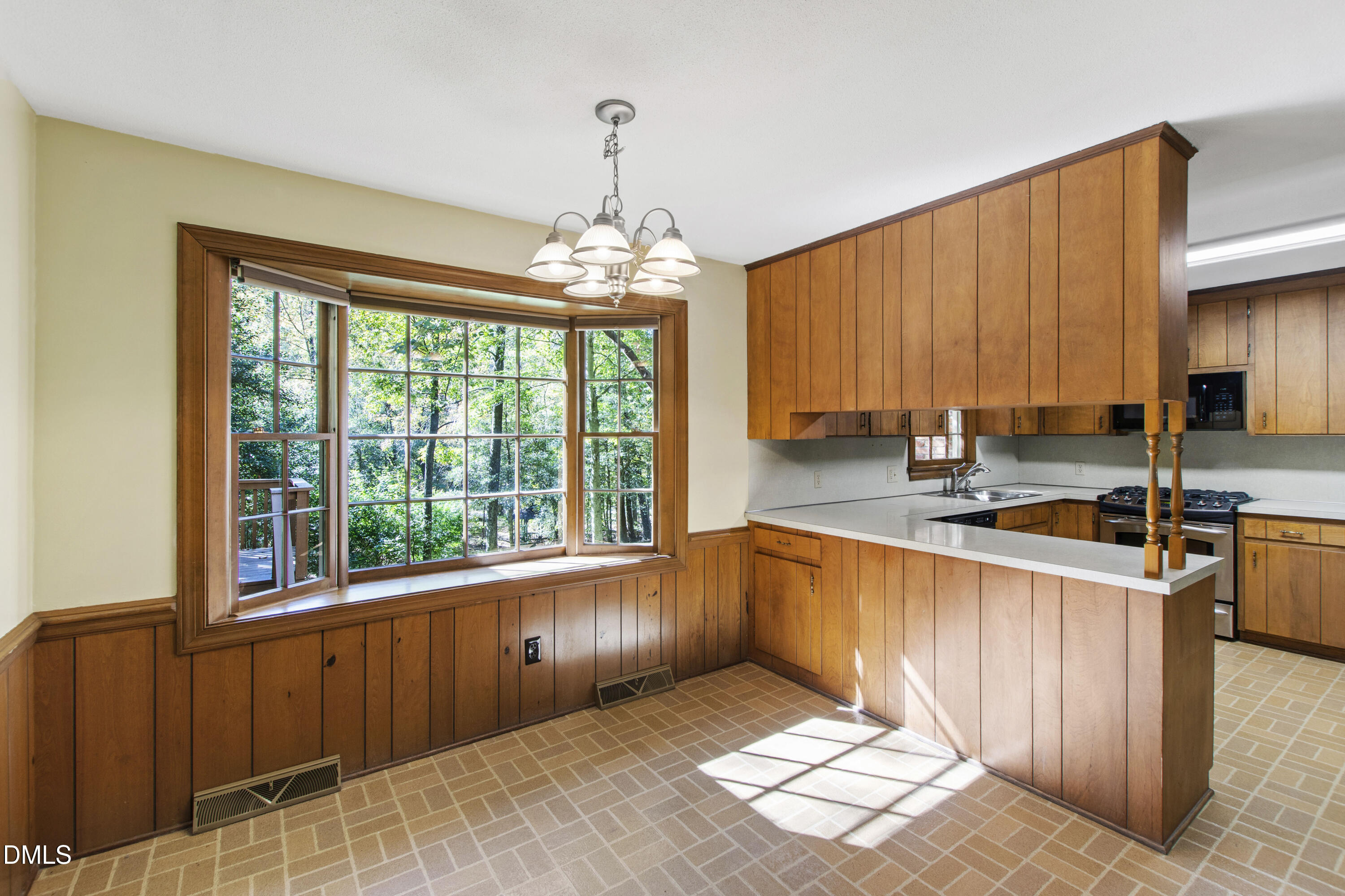 4208 Oak Park Road Raleigh, NC 27612 - Photo 12 of 66 a large kitchen with kitchen island granite countertop a large window