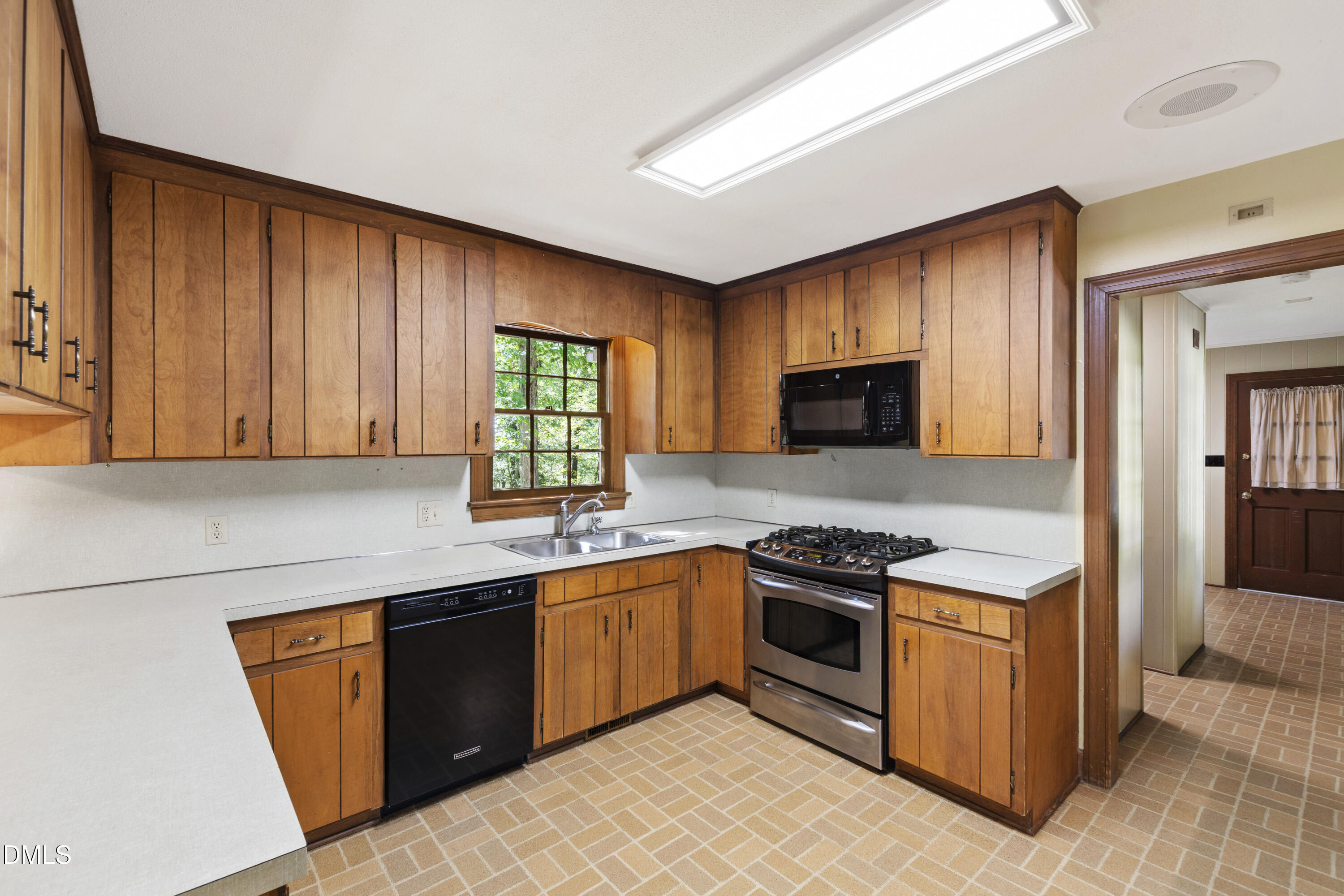 4208 Oak Park Road Raleigh, NC 27612 - Photo 14 of 66 a kitchen with a sink stove top oven and cabinets