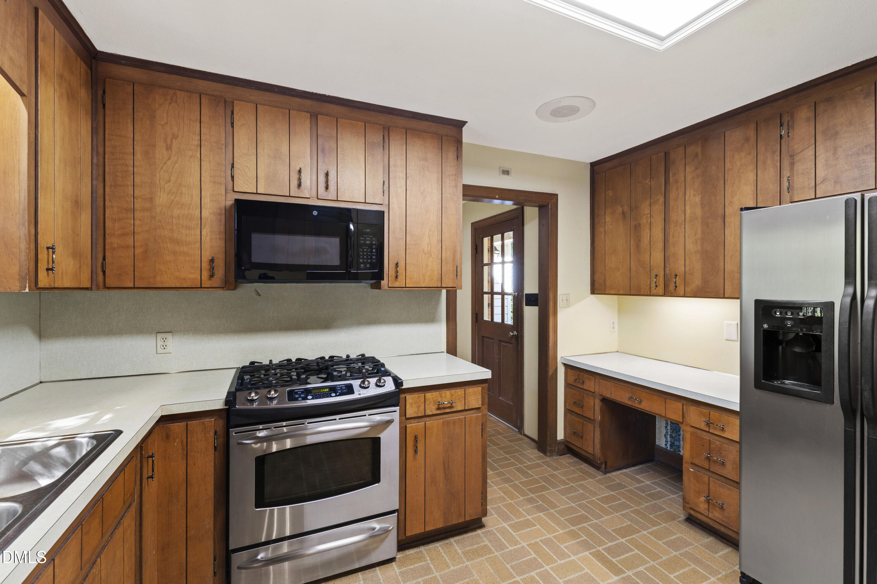 4208 Oak Park Road Raleigh, NC 27612 - Photo 18 of 66 a kitchen with stainless steel appliances a stove a microwave and cabinets