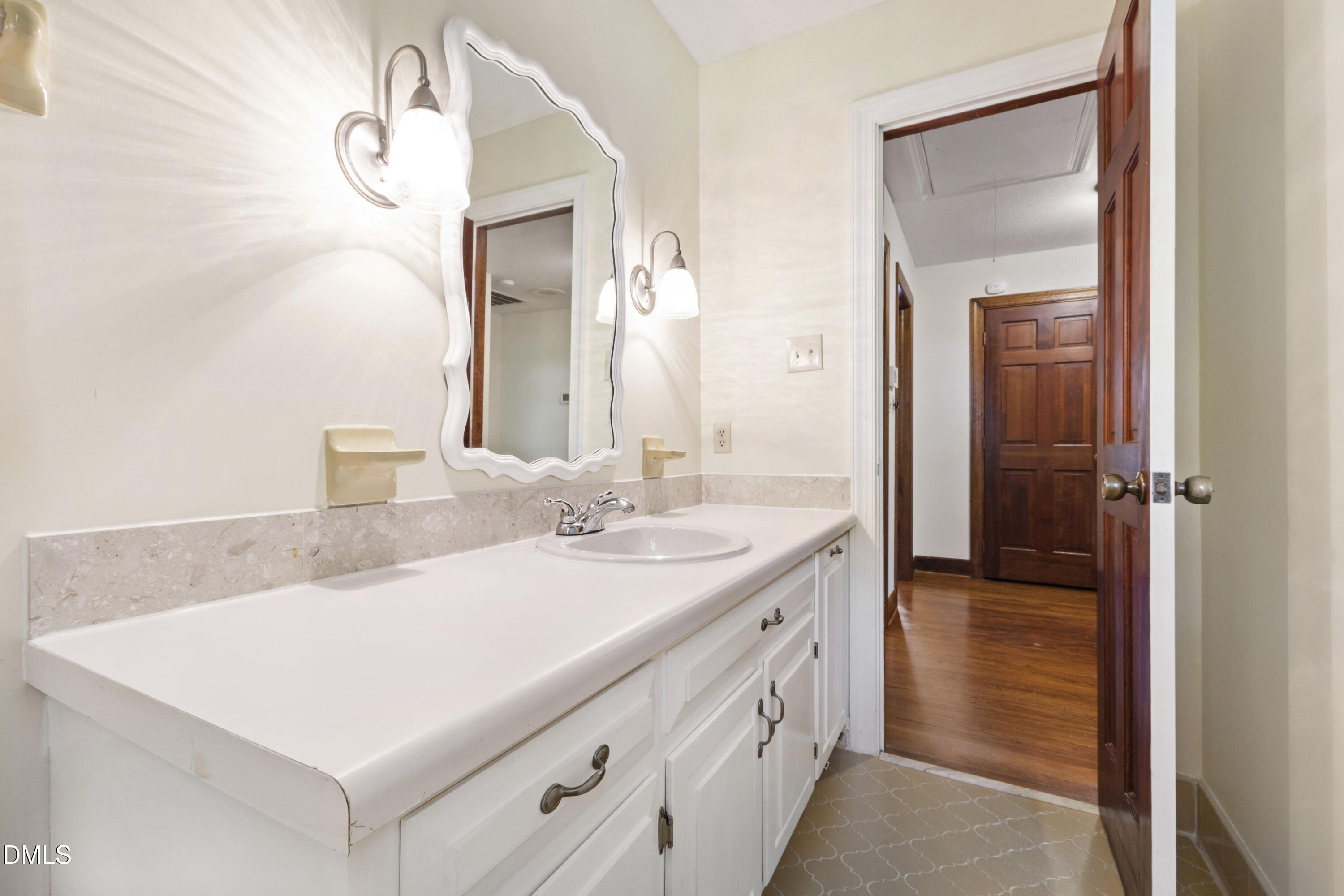 4208 Oak Park Road Raleigh, NC 27612 - Photo 41 of 66 a bathroom with a sink and a mirror