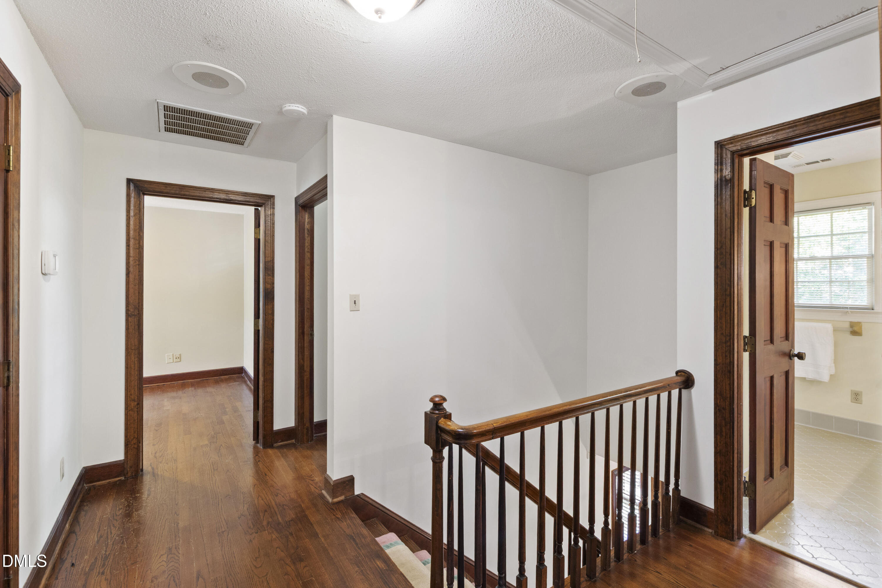 4208 Oak Park Road Raleigh, NC 27612 - Photo 43 of 66 a view of a hallway with wooden floor and a bathroom