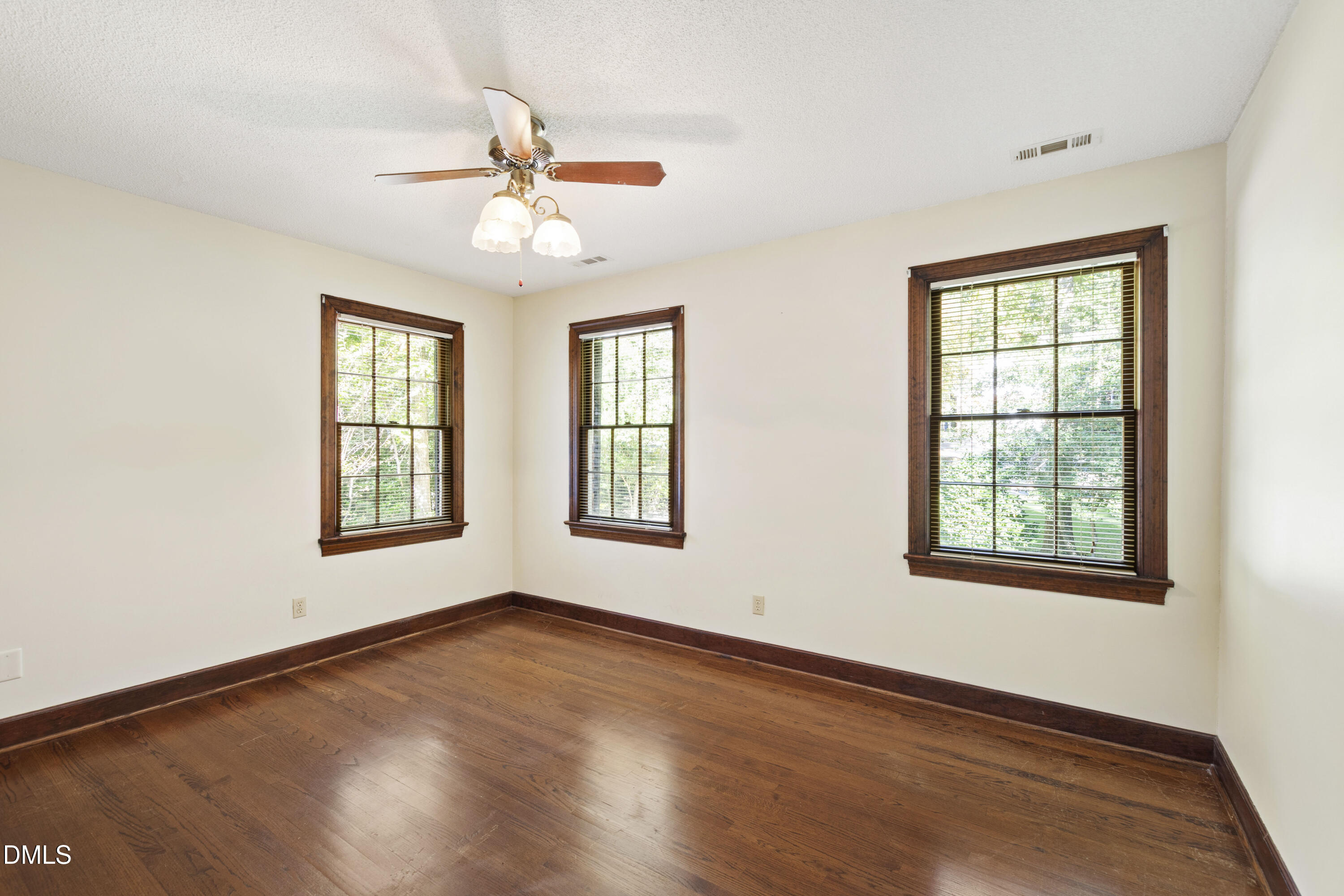 4208 Oak Park Road Raleigh, NC 27612 - Photo 44 of 66 a view of an empty room with wooden floor and a window