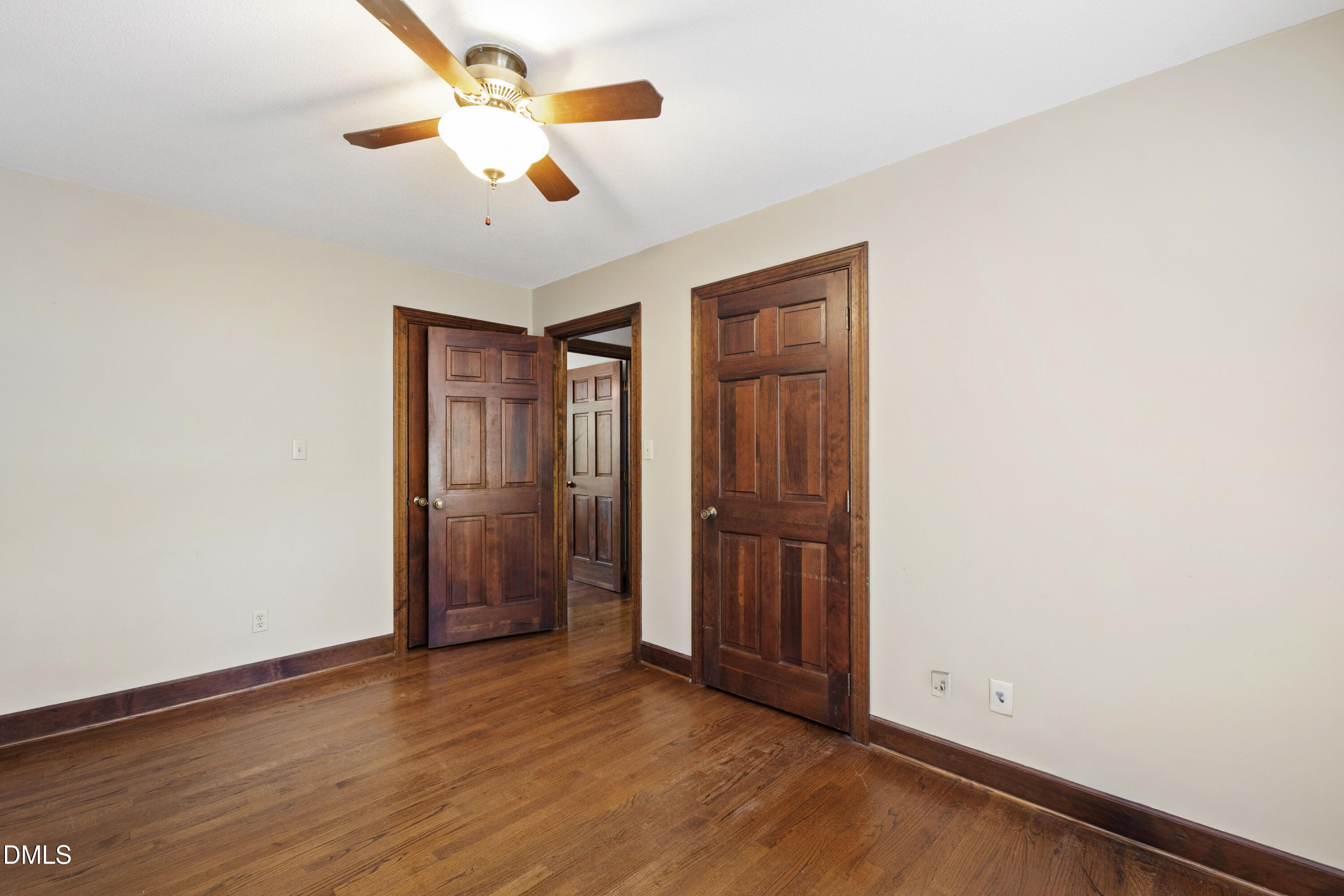 4208 Oak Park Road Raleigh, NC 27612 - Photo 47 of 66 an empty room with wooden floor and ceiling fan