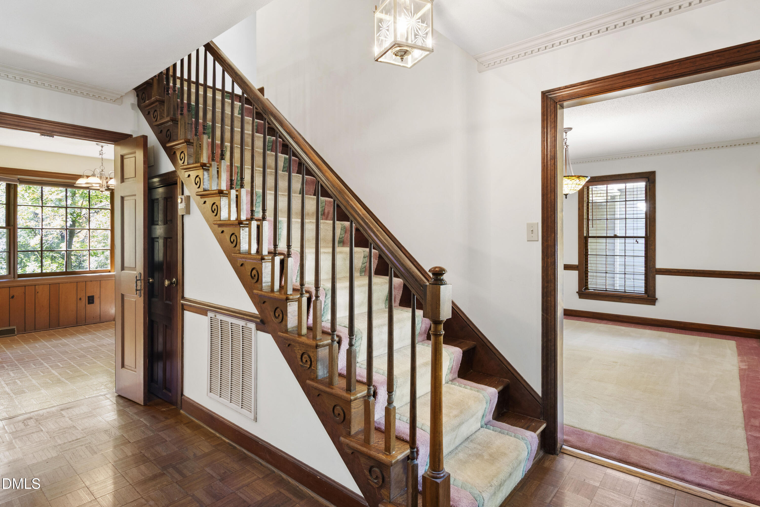 4208 Oak Park Road Raleigh, NC 27612 - Photo 7 of 66 a view of staircase with lots of frames on wall and windows