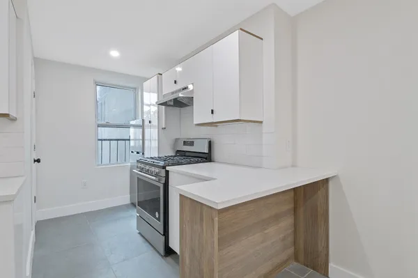a kitchen with a stove and a refrigerator