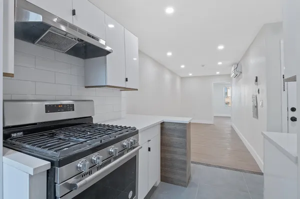 a kitchen with stainless steel appliances granite countertop a stove and a refrigerator