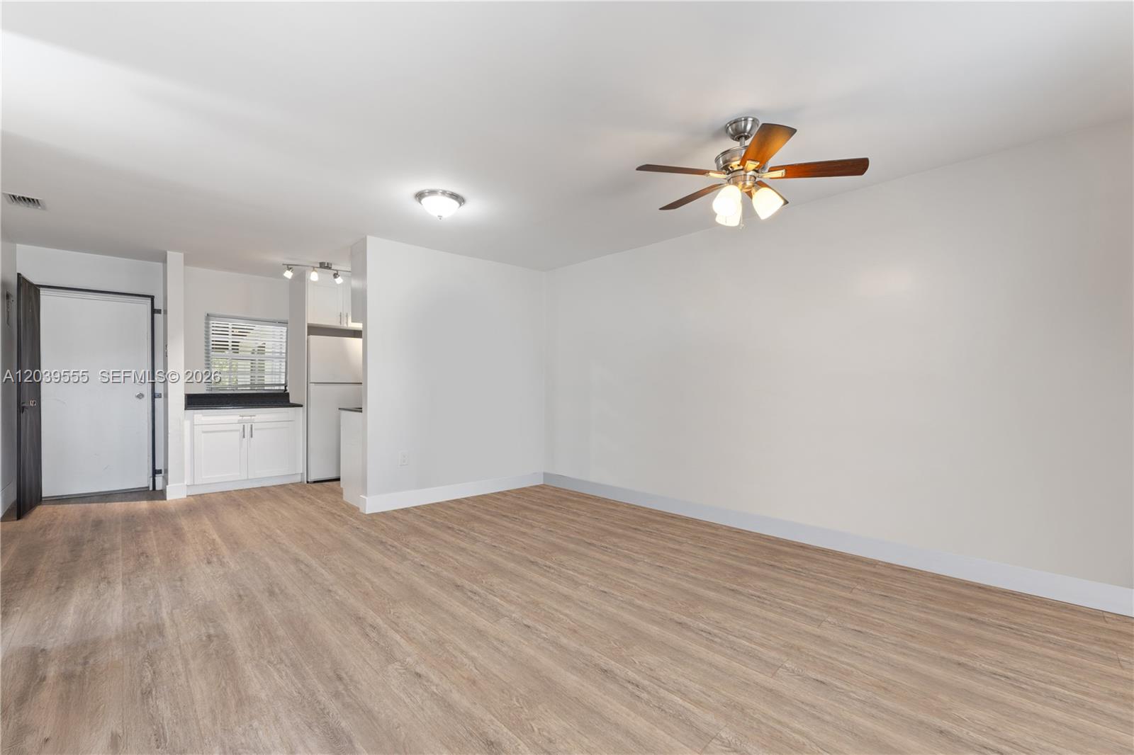 10544 Southwest 182nd Street Miami, FL 33157 - Photo 2 of 15 a view of a kitchen with wooden floor and a kitchen space with a sink