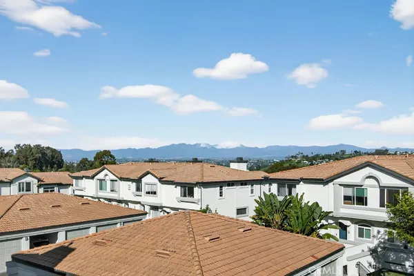 a view of a white house with a ocean view