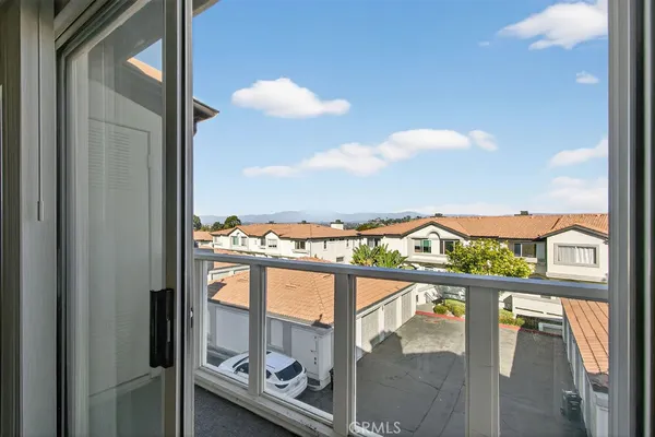 a view of a balcony with an outdoor seating