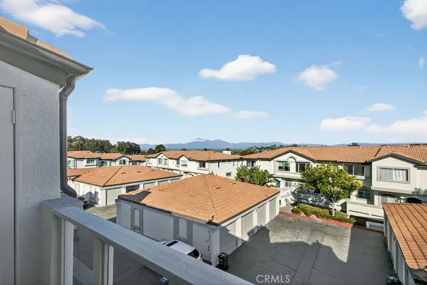 a view of a balcony with an outdoor seating