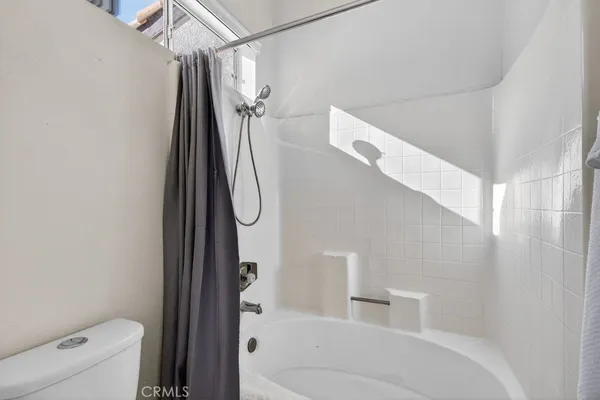 a bathroom with a shower and toilet