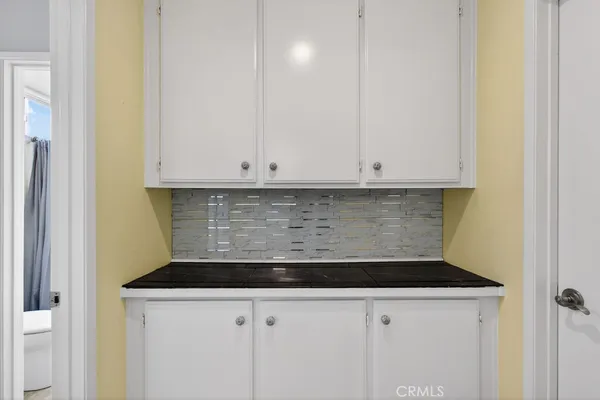 a view of a kitchen with granite countertop cabinets