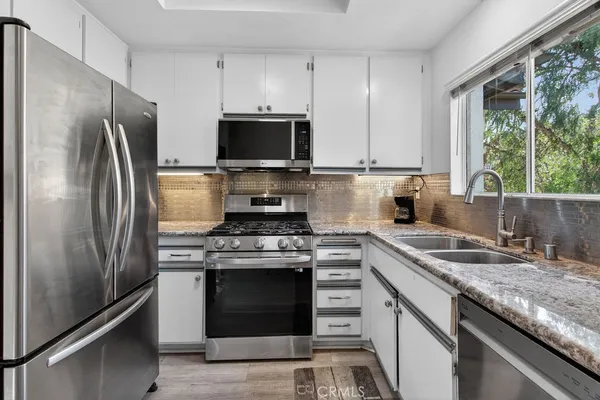 a kitchen with a stove microwave and refrigerator