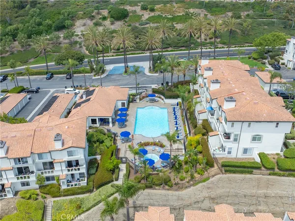 an aerial view of a house with a garden and lake view