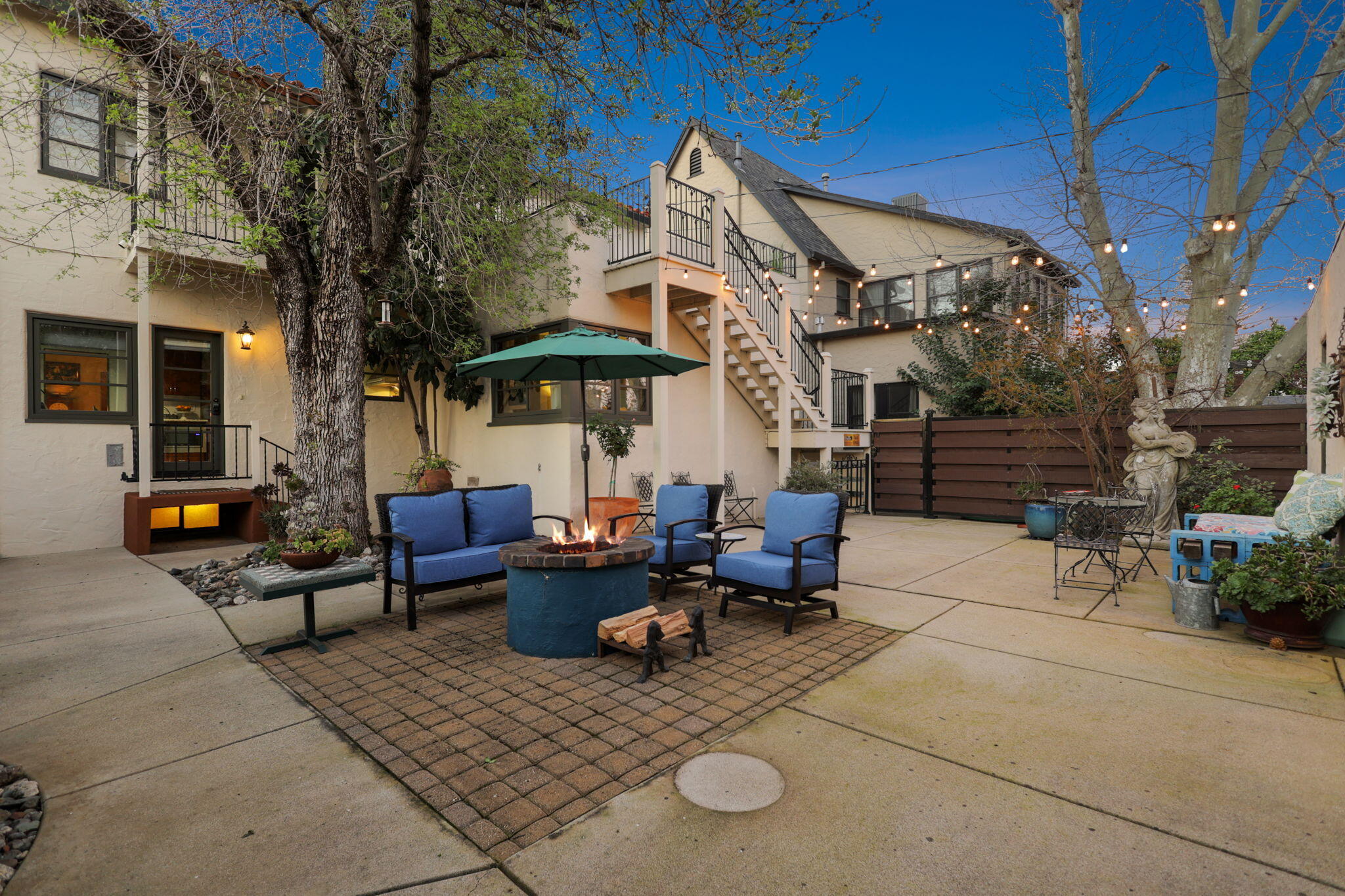1465 Riverside Drive Redding, CA 96001 - Photo 5 of 163 a view of a patio with couches table and chairs under an umbrella with a barbeque