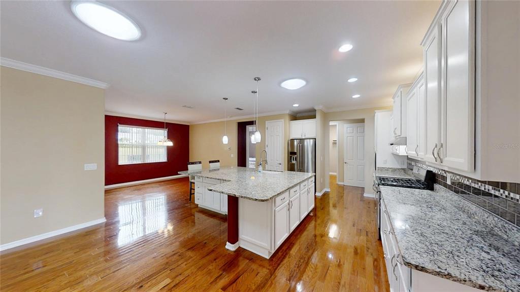 9273 Southwest 91st Ct Road Ocala, FL 34481 - Photo 15 of 38 a living room with stainless steel appliances granite countertop furniture wooden floor and window
