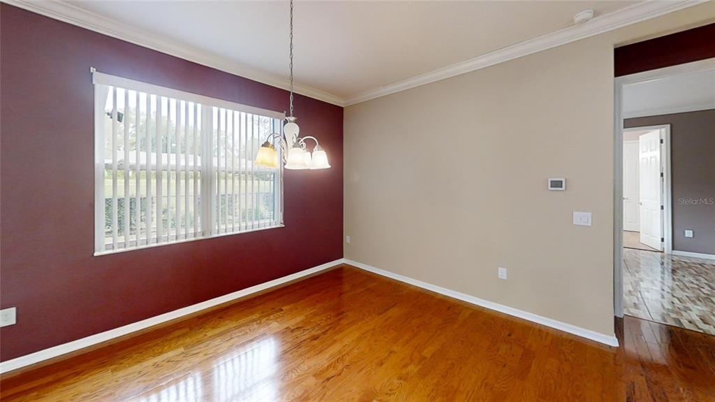 9273 Southwest 91st Ct Road Ocala, FL 34481 - Photo 17 of 38 a view of empty room with wooden floor and fan