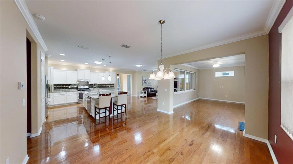 9273 Southwest 91st Ct Road Ocala, FL 34481 - Photo 18 of 38 a view of a dining room and livingroom with furniture wooden floor a chandelier