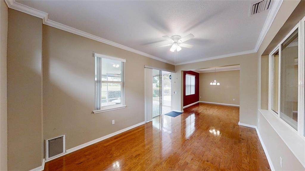 9273 Southwest 91st Ct Road Ocala, FL 34481 - Photo 20 of 38 a view of an empty room with window and wooden floor