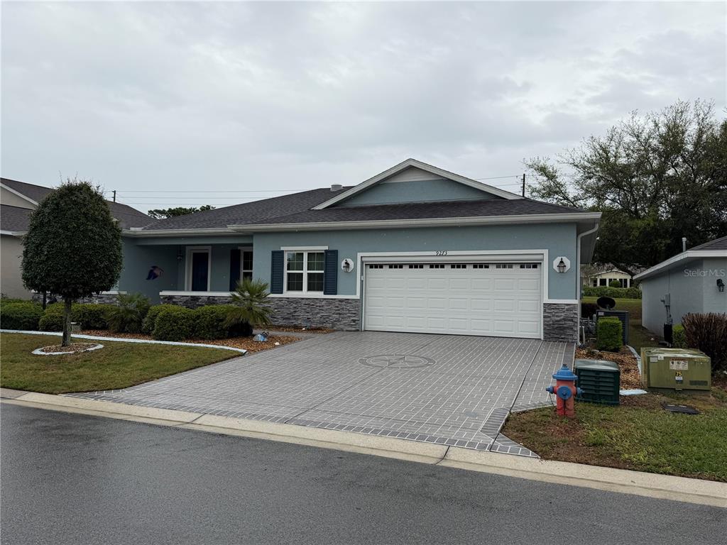 9273 Southwest 91st Ct Road Ocala, FL 34481 - Photo 2 of 38 a front view of a house with a yard and garage