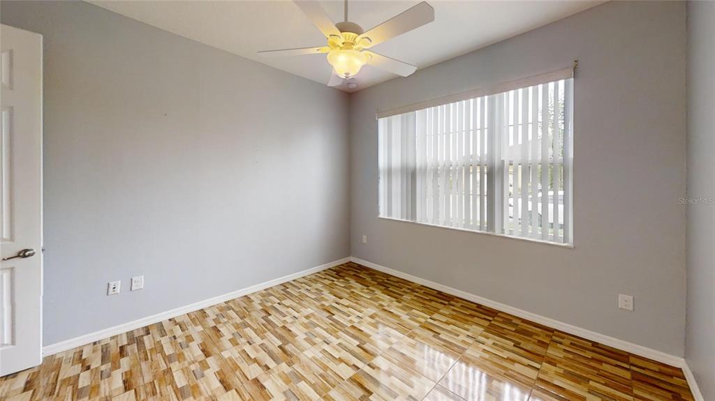 9273 Southwest 91st Ct Road Ocala, FL 34481 - Photo 28 of 38 a view of an empty room with window and a chandelier fan