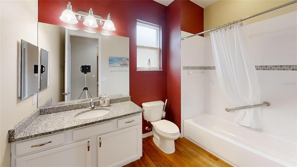 9273 Southwest 91st Ct Road Ocala, FL 34481 - Photo 30 of 38 a bathroom with a granite countertop sink toilet and shower