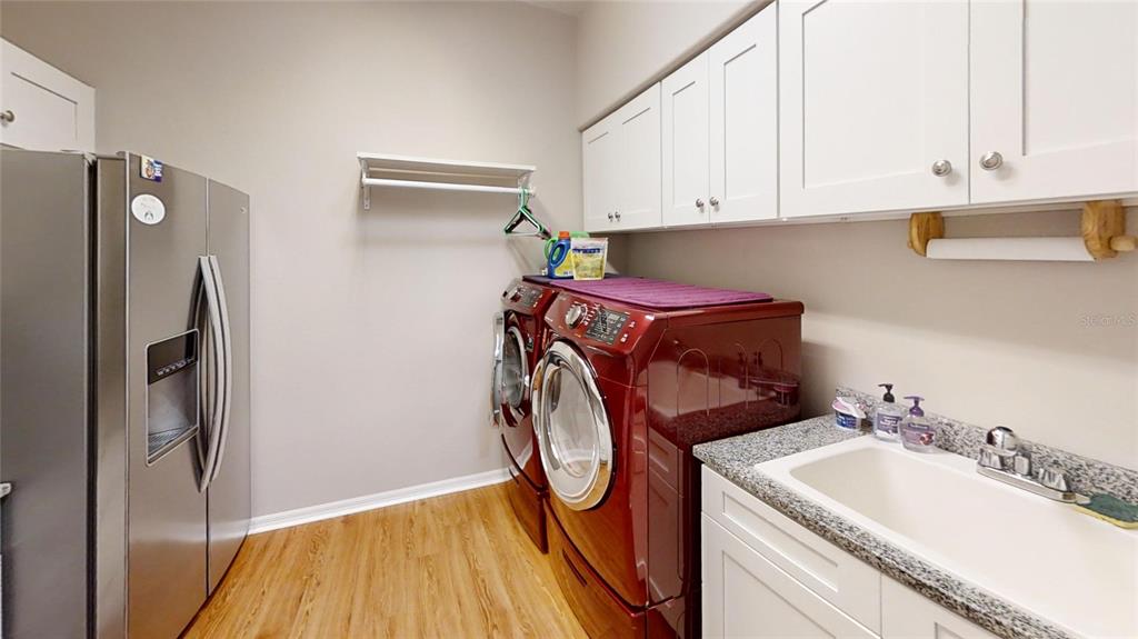 9273 Southwest 91st Ct Road Ocala, FL 34481 - Photo 32 of 38 a utility room with sink dryer and washer