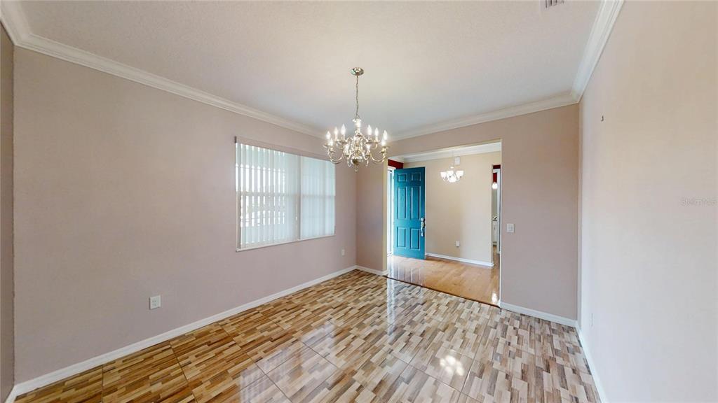 9273 Southwest 91st Ct Road Ocala, FL 34481 - Photo 5 of 38 a view of an empty room with window and wooden floor