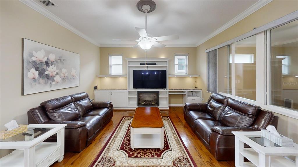 9273 Southwest 91st Ct Road Ocala, FL 34481 - Photo 7 of 38 a living room with furniture fireplace and flat screen tv