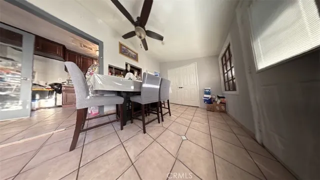 a living room with furniture and a painting on the wall