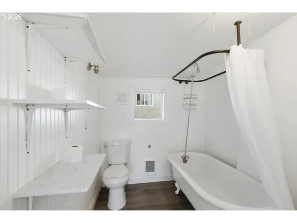 a bathroom with a toilet a sink and bathtub