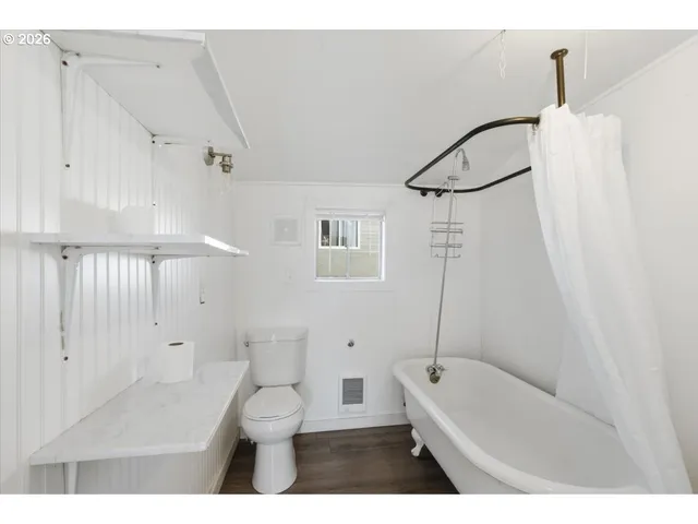 a bathroom with a toilet a sink and bathtub
