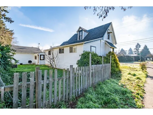 a view of a house with wooden fence