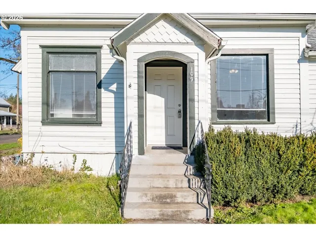 a front view of a house with a garden