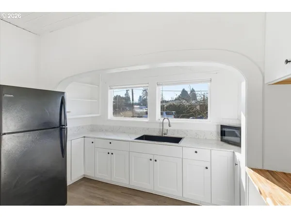 a kitchen with a sink and a refrigerator