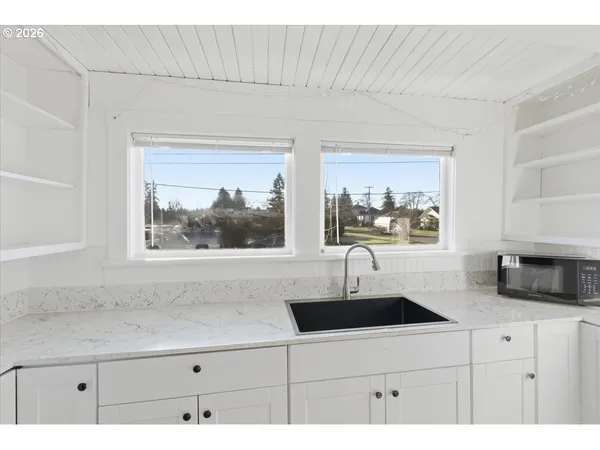 a kitchen with a sink and large window