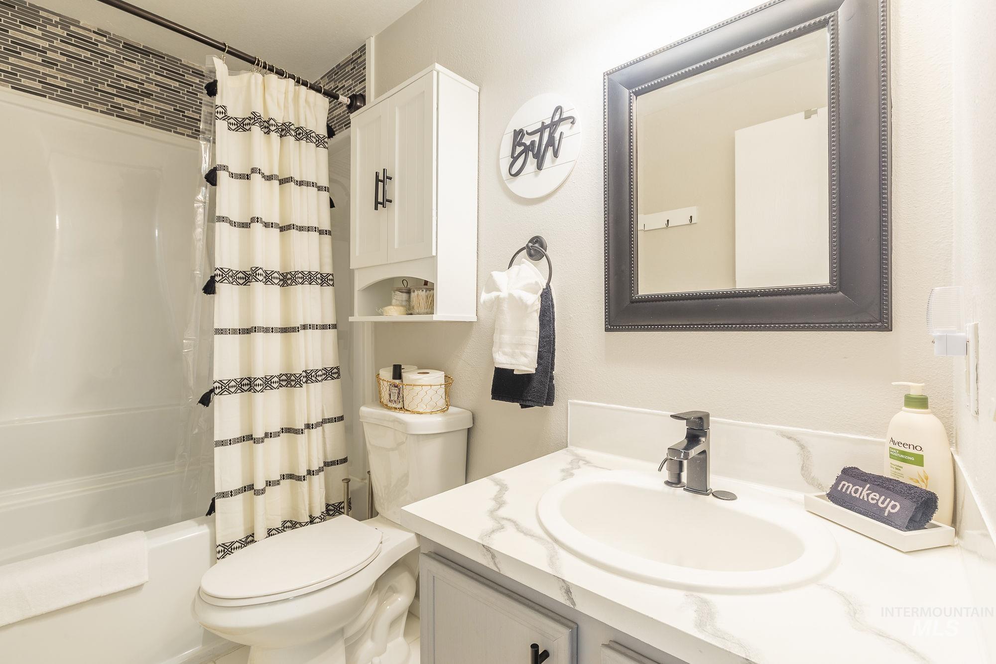 352 North Eagle Road Eagle, ID 83616 - Photo 28 of 44 Bathroom with vanity and shower / bath combination with curtain