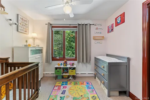 a room with furniture a baby crib and a book shelf