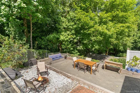 a backyard of a house with outdoor seating