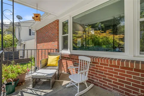 a view of a chairs and table in the balcony
