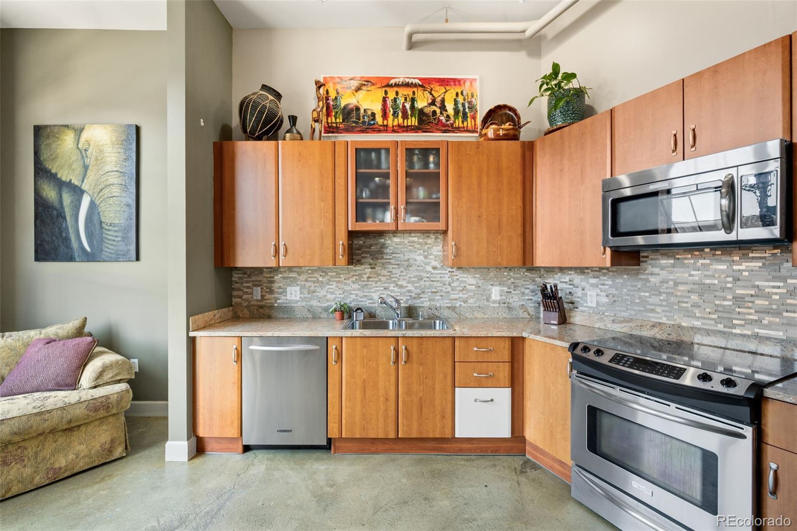 2500 Walnut Street, Unit 201 Denver, CO 80205 - Photo 6 of 30 a kitchen with stainless steel appliances granite countertop a stove and a microwave