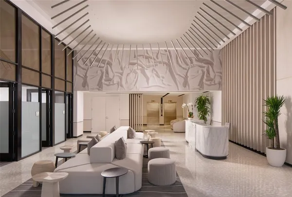 a living room with furniture and a potted plant