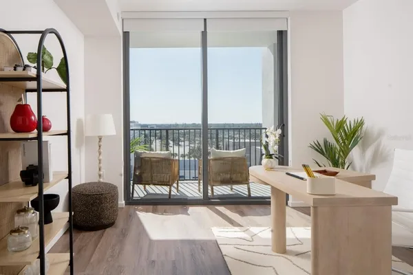 a living room with furniture and wooden floor