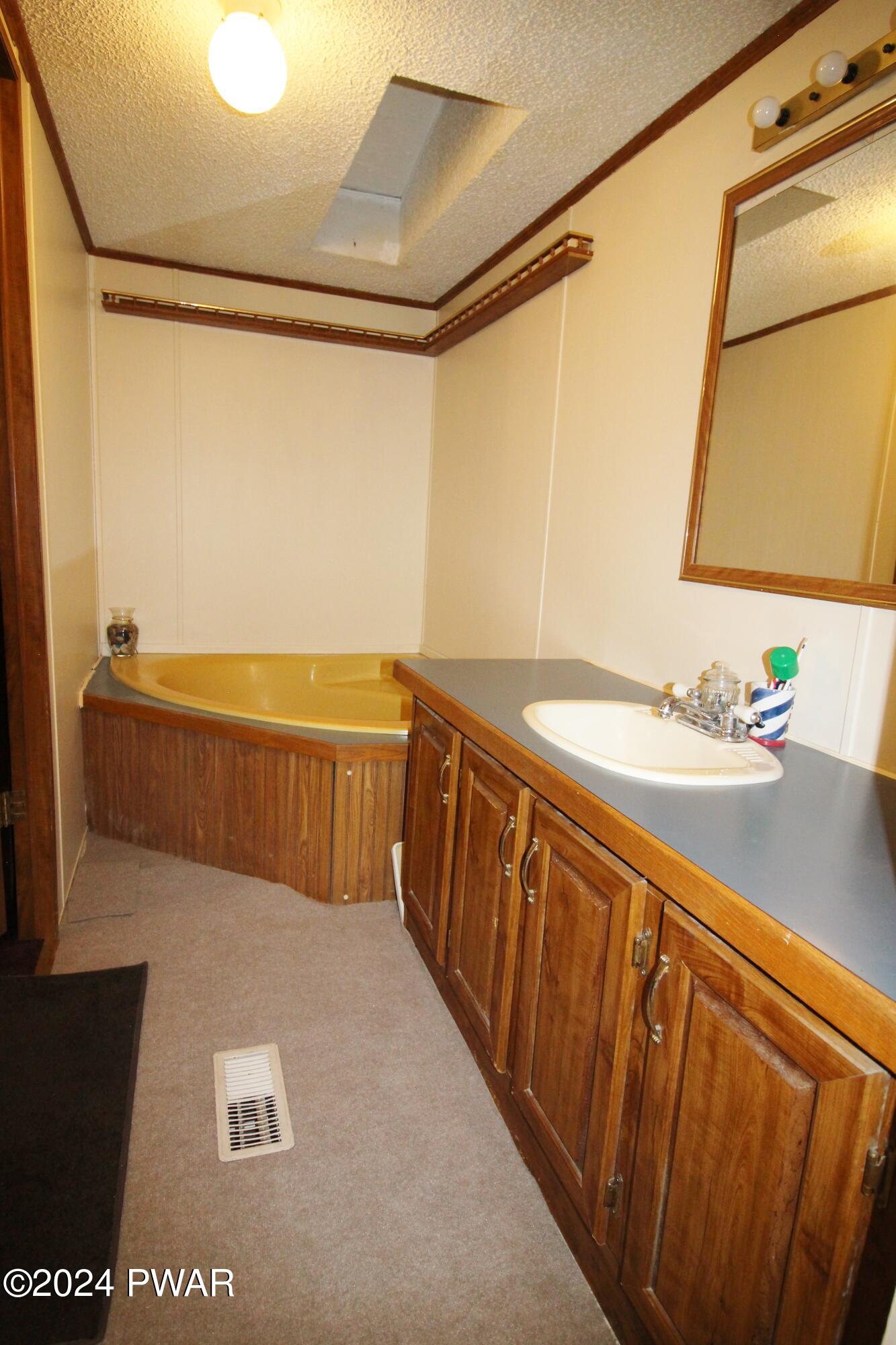 10 Madison Estate Moscow, PA 18444 - Photo 28 of 45 a bathroom with a sink and a mirror