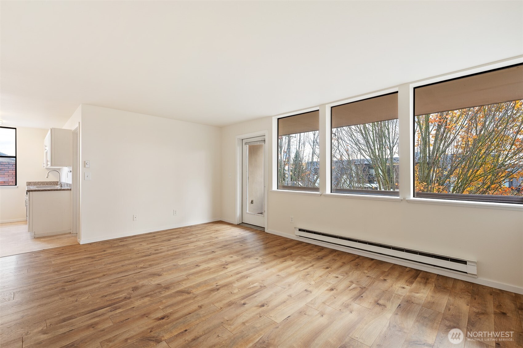 802 North 43rd Street Seattle, WA 98103 - Photo 11 of 18 a view of an empty room with wooden floor and a window